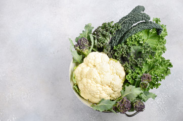 Different kinds of fresh organic cabbage on a gray concrete background. Green and Purple Cale,...