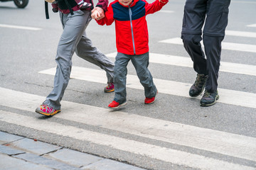 People walking across a street in Hanoi, Vietnam. Closeup