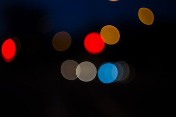 Beautiful specks of color bokeh on a dark background. Horizontal.