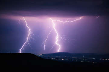 Fototapeta na wymiar lightning storm over city at night