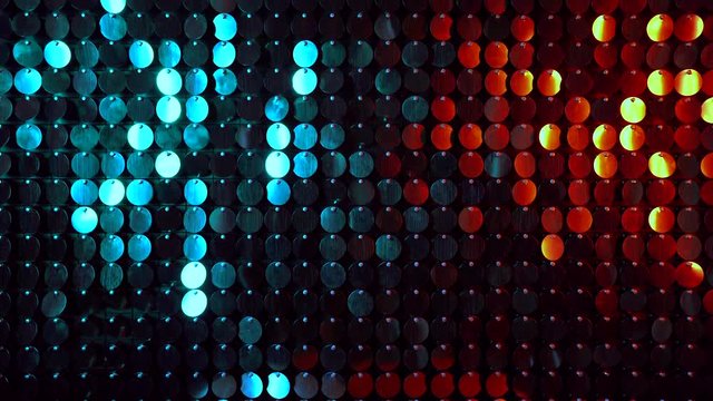 Shiny kinetic surface panel illuminated by gold and turquoise light in luxury boutique. Flickering background for interruptions or text savers. Mirror sequins sway by wind blowing.