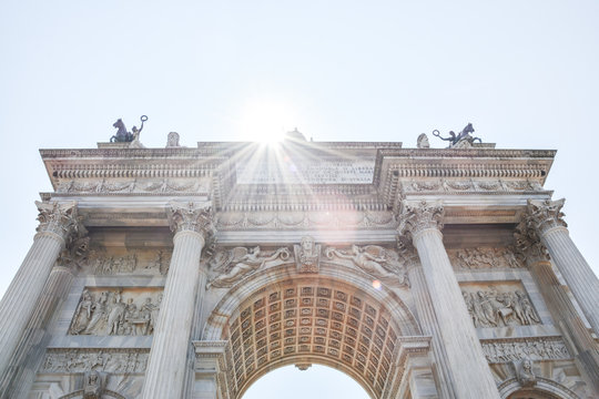 Arch of Peace,  Arco della pace, neoclassical landmark. City gate in the center of the Old Town of Milan, Sempione park. Wide view of a famous monument in Milan, Lombardy, Italy, Europe.