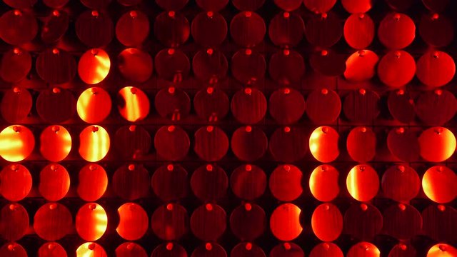 Close up of red sequins sparkling reflective background. Abstract kinetic glitter wall moving. Night club decoration. Can be used as transitions, added to modern projects,art backgrounds.