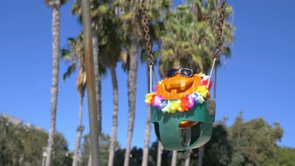 Happy Halloween pumpkin on the swing in 4K slow motion 60fps