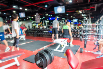 Blurred of fitness gym center interior background