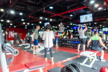 Blurred of fitness gym center interior background
