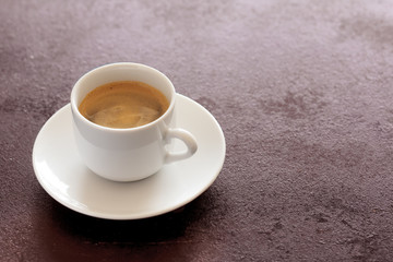 Obraz na płótnie Canvas Hot cup of espresso coffee on a table