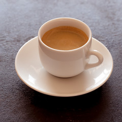 Hot cup of espresso coffee on a table