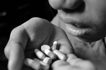 Young women are taking drugs, sitting in low light