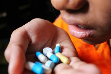 Young women are taking drugs, sitting in low light