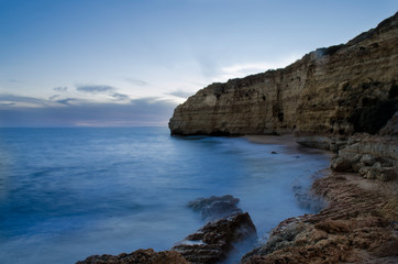 Fototapeta na wymiar Sunset in the Vale de Centianes Beach, Carvoeiro, Algarve, Portugal. Selective focus and silk effect.