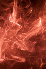 Red smoke on a black background.