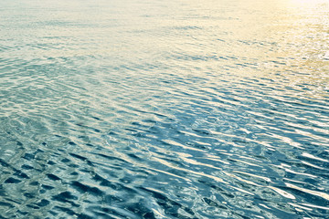 The texture of the water of the sea, ocean with reflecting sun glare.