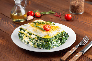 lasagna with spinach and cheese on a plate garlic mint cheese sour cream black pepper olive oil in...