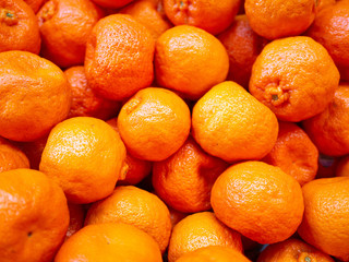 Bunch of fresh oranges mandarins for sale in the market close up top view