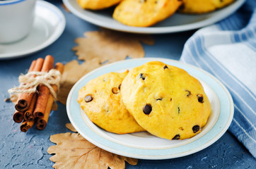 Chocolate chips pumpkin cookies with cups of coffee