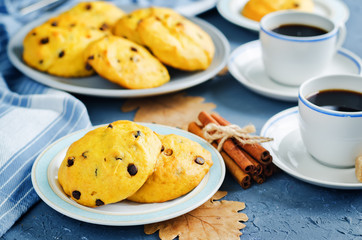 Chocolate chips pumpkin cookies with cups of coffee