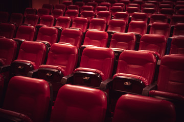 Red leather movie seats with lights dimmed