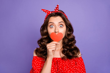 Beautiful lady holding little heart figure card hiding mouth promise to shut up wear red dress isolated purple background