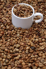 medium roasted coffee beans with white  porcelain cup