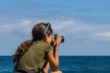 young girl taking photo with reflex camera