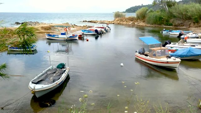 Small natural harbor with fishing boats in Agia Paraskevi area, Halkidiki Greece
