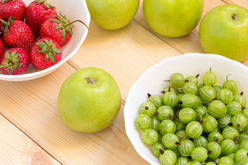Summer harvest background. Close-up fruits and berries on wooden table.