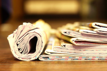 Rolled Newspapers and Pages with Headlins and Articles. Latest News in Morning Papers 