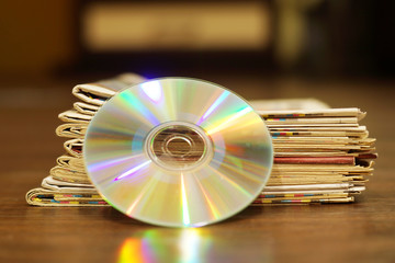 Stack of Newspapers and CD or DVD Disc       