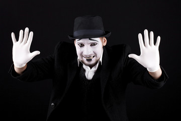 mime shows theatrical emotions on black background