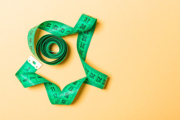 Top view of measure tape curtailed into a spiral with copy space. Concept of sewing accessory or...