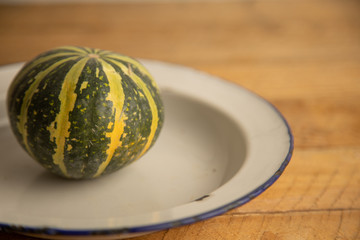 Diverse assortment of pumpkins on a wooden background. Autumn harvest...