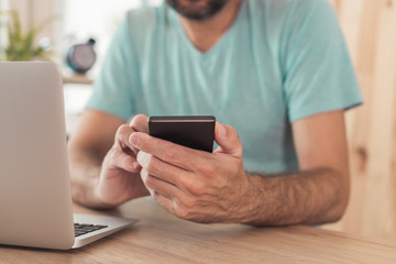 Freelancer using smart phone in home office