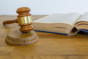 wooden gavel and books on wooden table