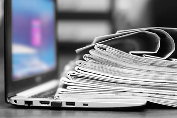 Newspapers and Laptop. Magazines Stacked on Computer. Tabloid Journals and Open Notebook - Information and News on Paper Pages or on Device Screen by Internet 