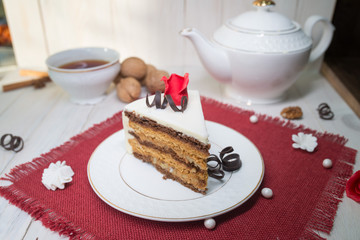 chocolate cake slice with a white cup of tea