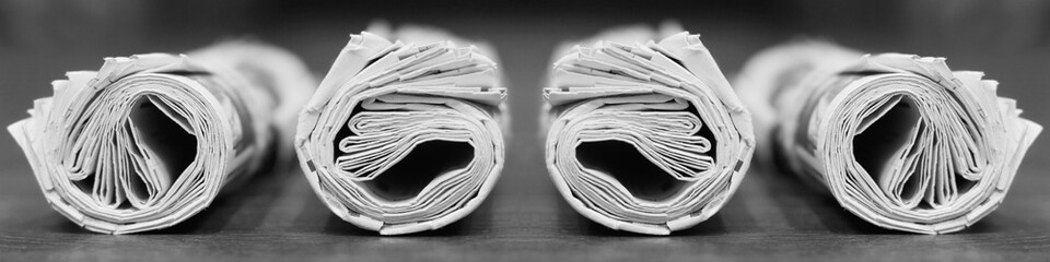 Long horizontal banner with rolled and folded newspapers and magazines in retro style. Concept for...