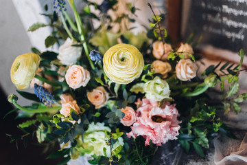 Beautiful composition with flowers on the tables and candles for guests at a wedding or a birthday party