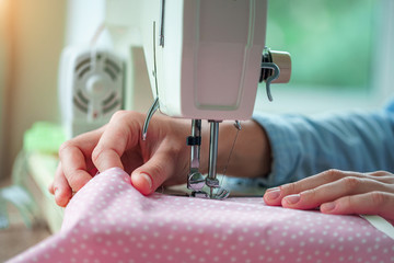 Electric sewing machine close up during sewing process