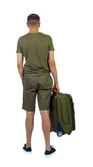 Back view of man in shorts with suitcase.
