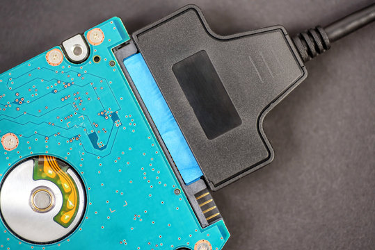 sata cable connected to hdd 2.5 hard drive disk on dark background closeup view