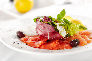 Gourmet, restaurant, delicious dinner food - close up of Fish Dish with Lemon and Fresh Basil Leaves