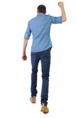 Back view of a man who goes and swings his fist.