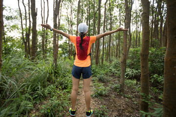 Ultramarathon runner cheering in tropical rainforest