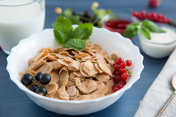 Healthy tasty breakfast multigrain wholewheat healthy cereals with strawberries, raspberries, black currants and red currants.