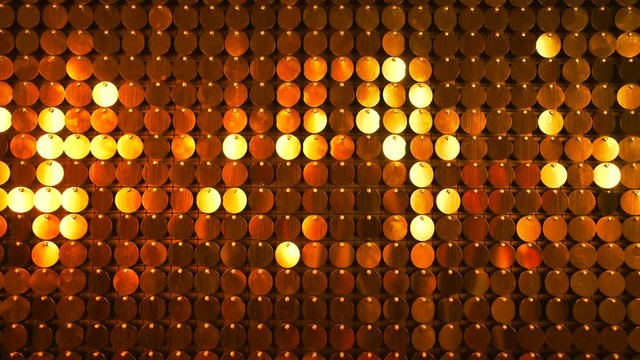 Gold sequins sparkling reflective background. Abstract kinetic glitter wall moving. Night club decoration. Can be used as transitions, added to modern projects,art backgrounds.