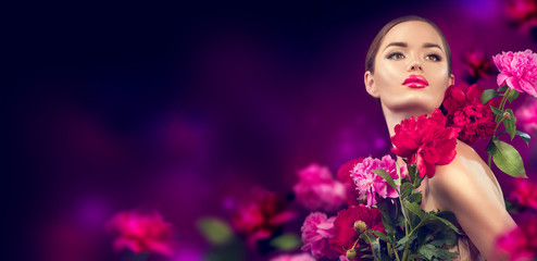 Beauty girl with purple, red, pink peony flowers portrait. Beauty high fashion model woman with...