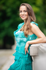 Beautiful shapely woman in a turquoise dress