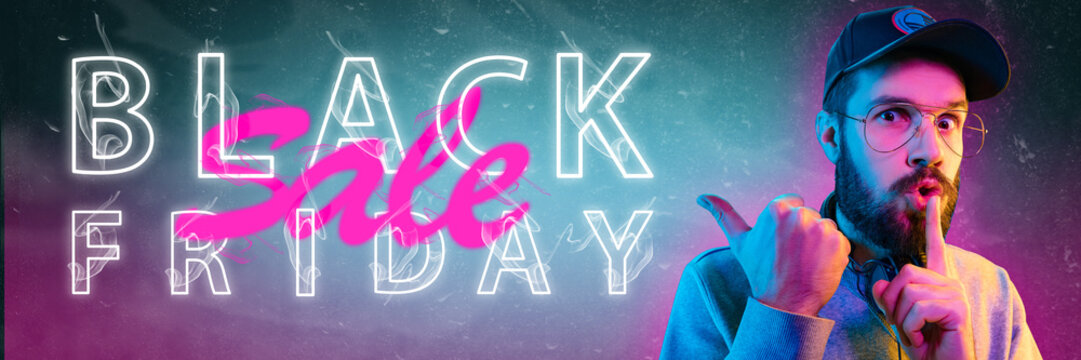 Black friday, sales concept. Neon lighted letters on gradient background. Astonished man whispering. Negative space. Modern design. Contemporary art. Creative conceptual and colorful collage.
