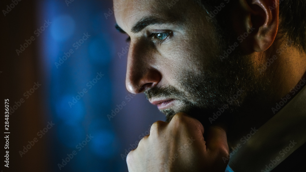 Poster Close-up of a Man's Face Working on a Computer. He Sits in a Dark Apartment.